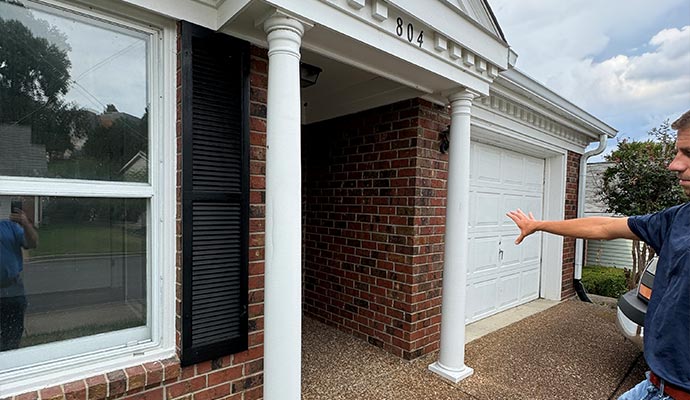 Professional inspector inspecting a house exterior