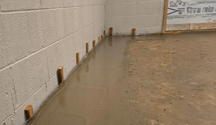 Interior basement drainage system installation