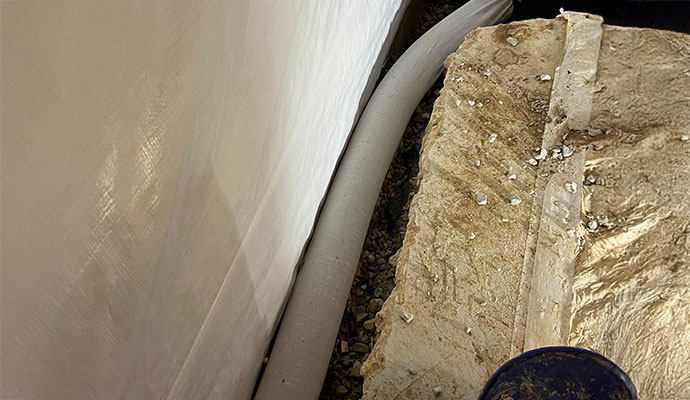 Interior perimeter drainage system installation